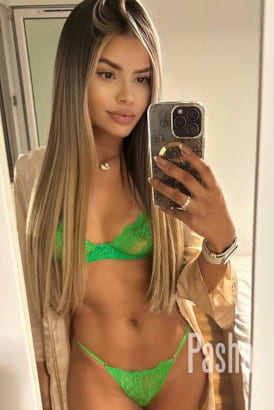 Sweet girl in a green bikini taking a selfie