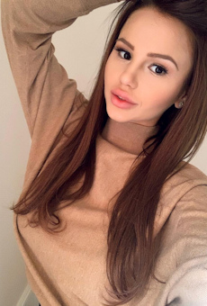 Sexy girl with long silky brown hair taking a selfie