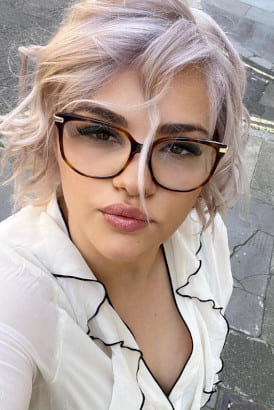 Blonde beauty wearing glasses in a close up selfie shot