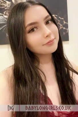 Fresh faced young brunette taking a close up selfie