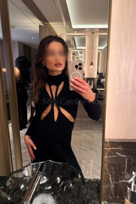Hot slender brunette taking a selfie in a marble tiled bathroom