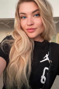 Pretty blonde Russian girl taking a close-up selfie