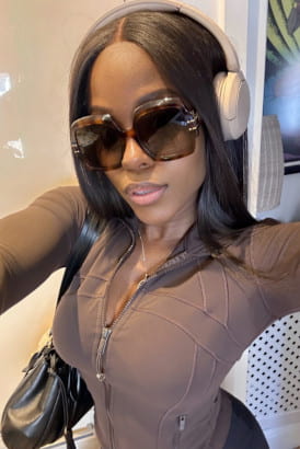 Hip busty slim black girl wearing headphones and big sunglasses
