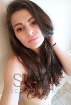 Tiny slim brunette escort in a selfie photo