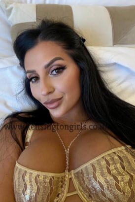 Busty Turkish girl laying on a bed and taking a selfie