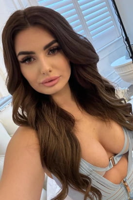 A young busty brunette girl taking a close up selfie