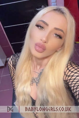Hot blonde girl blowing a kiss in a selfie